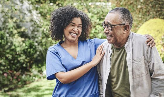 Elderly man being guided by nurse